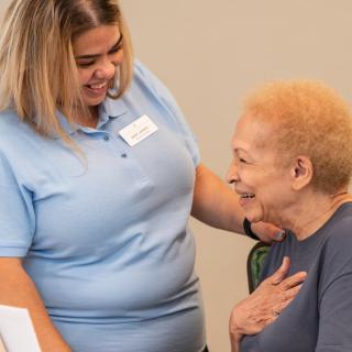 A caregiver shares a moment of support and kindness with an elderly individual.