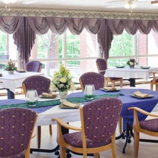 A well-decorated dining area with elegantly set tables and comfortable chairs.