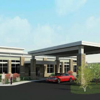 A modern architectural design featuring a welcoming entrance with landscaped surroundings.