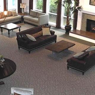 A spacious living room with modern furniture and a fireplace.