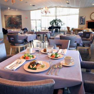 Elegant restaurant dining area with neatly arranged tables and plated meals.