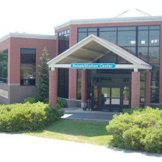 A modern building featuring a welcoming entrance and landscaped surroundings.