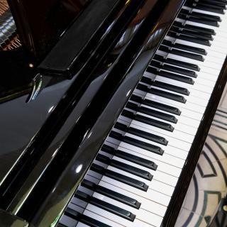 A close-up of a piano keyboard showcasing its black and white keys.