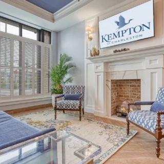 A stylish hotel lobby featuring elegant furniture and a fireplace.