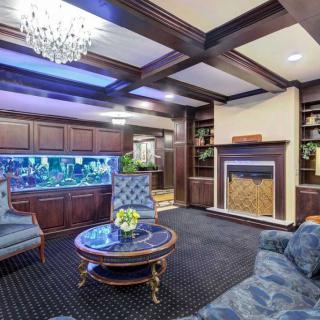 Luxurious living room with a large aquarium and elegant wooden interior.