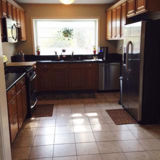 A modern kitchen with wooden cabinets and stainless steel appliances.