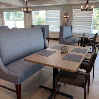 A modern restaurant interior with booth seating and neatly arranged tables.