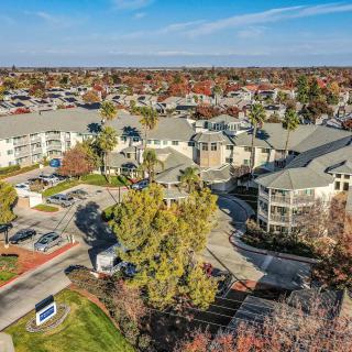Aerial view of a suburban residential area with apartment buildings surrounded by trees.