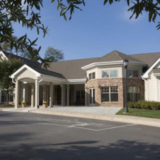 A modern residential building featuring a welcoming entrance and well-maintained landscape.