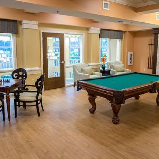 A cozy game room featuring a pool table and seating area.