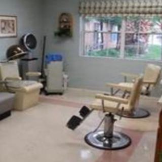 A cozy beauty salon with barber chairs and hair styling equipment.