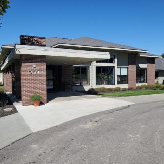 A modern residential building with a brick facade and a driveway.