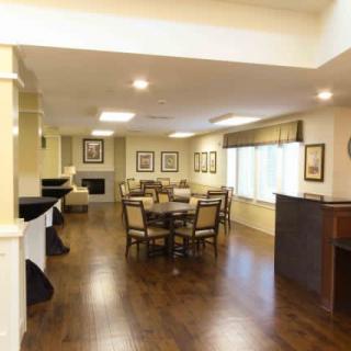 A bright dining area with wooden flooring and elegant furniture.