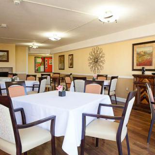 A well-decorated dining room with neatly arranged tables and chairs.