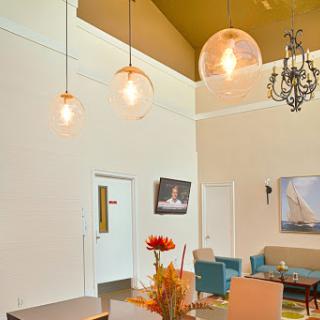 A stylish and modern living space with unique lighting fixtures and comfortable seating.