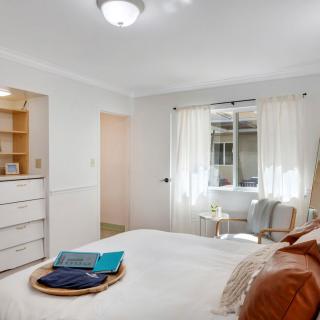 A bright and cozy bedroom with modern decor and natural light.