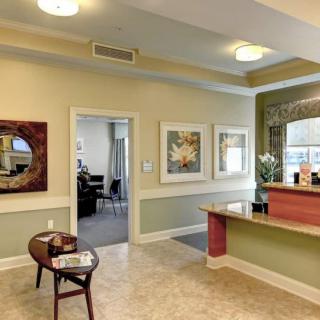 A well-decorated reception area with comfortable seating and artwork on the walls.