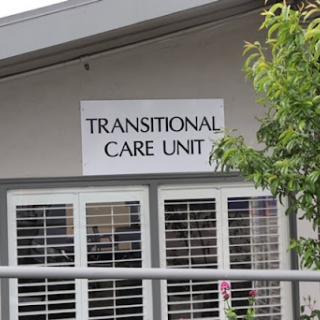 Exterior view of a Transitional Care Unit, indicating a specialized healthcare facility.