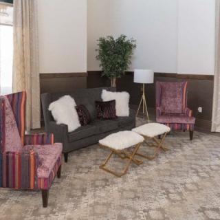 A cozy living room with a stylish sofa, colorful chairs, and elegant decor.