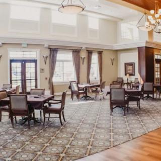 Spacious dining area with elegant furnishings and natural lighting.