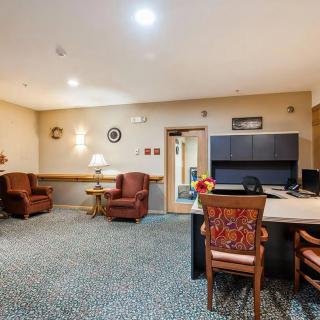 A cozy office interior with comfortable seating and a well-organized desk area.