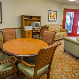 A cozy living room with a round table and comfortable seating.
