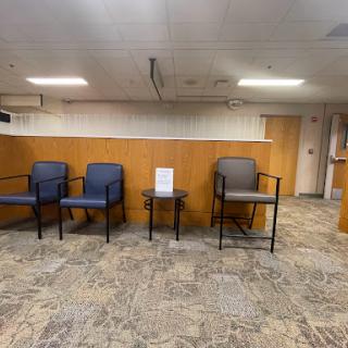 A view of a waiting room with chairs and a small table.