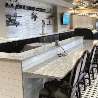 A modern bar counter with seating in an empty restaurant.