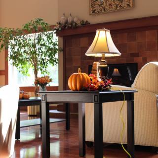 Cozy living room with autumn decorations and natural lighting.