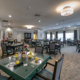 A spacious dining area with neatly arranged tables and comfortable seating.