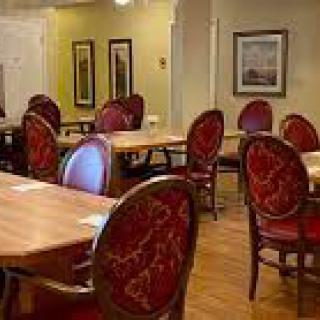 An elegant dining area with ornate chairs and wooden tables.