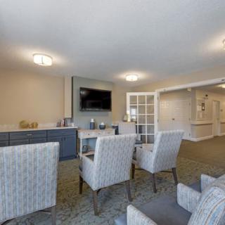 A modern living room with comfortable seating and a wall-mounted television.
