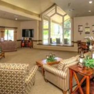 A spacious living room with comfortable seating and large windows.