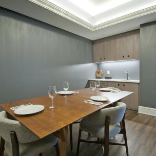 A modern dining room with a sleek wooden table and minimalist decor.