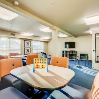 A cozy lounge area featuring comfortable seating and a modern table.