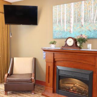 A cozy living room featuring a modern fireplace and comfortable seating.