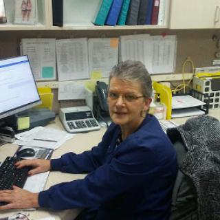 A woman working at her desk in an office environment.