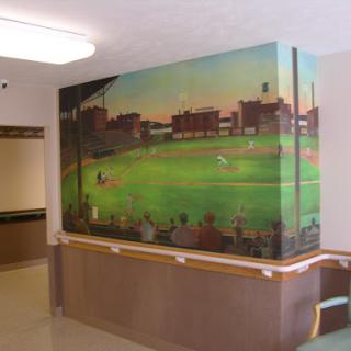 A vibrant mural depicting a baseball scene, enhancing the interior of a public space.