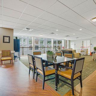 A spacious and modern lounge area with tables and chairs.