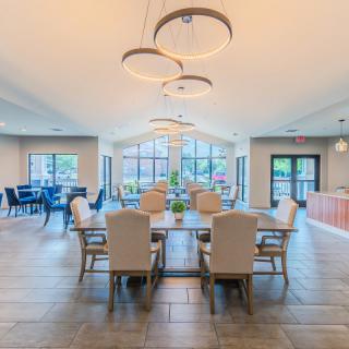 A modern and spacious dining area with elegant lighting and comfortable seating.
