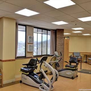 A spacious rehabilitation center equipped with exercise machines designed for patient fitness and recovery.