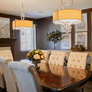 A beautifully designed dining room featuring elegant furniture and warm lighting.