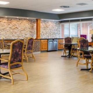 A modern dining area with neatly arranged tables and chairs.