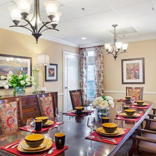 A well-decorated dining room with an elegant table setting and ambient lighting.