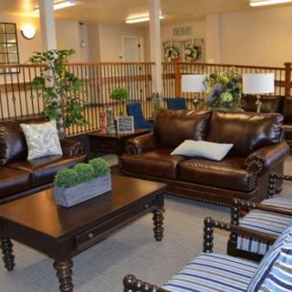 A cozy living room with leather sofas and elegant decor.