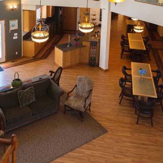 A spacious lobby area with comfortable seating and wooden flooring.