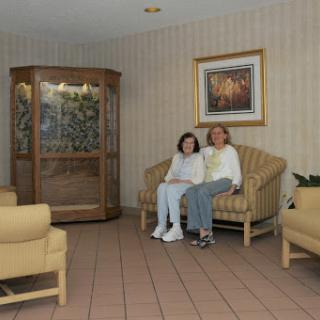 A cozy living room seating area featuring a couple relaxing on a couch.