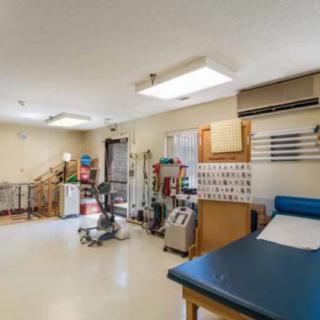 A clean and organized medical examination room with essential equipment.