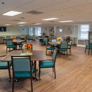 A spacious community dining area with tables and chairs arranged neatly.