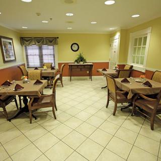 A cozy dining area with neatly arranged tables and chairs in a well-lit room.